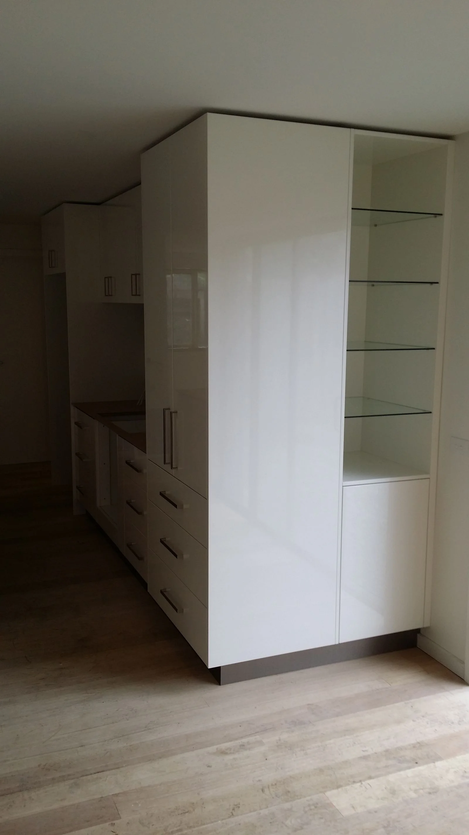 Built-in wardrobe with mirrored sliding doors and side cabinetry