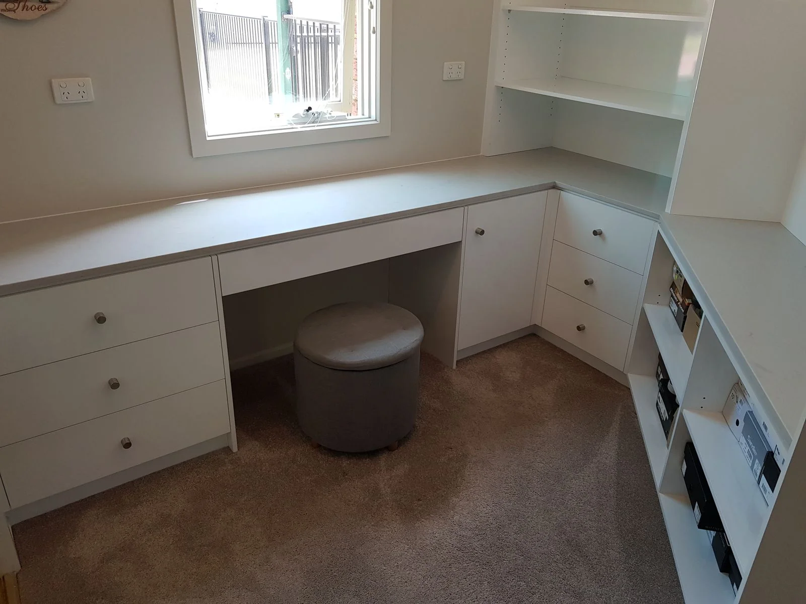 Built-in wardrobe with white sliding doors and floor-to-ceiling storage