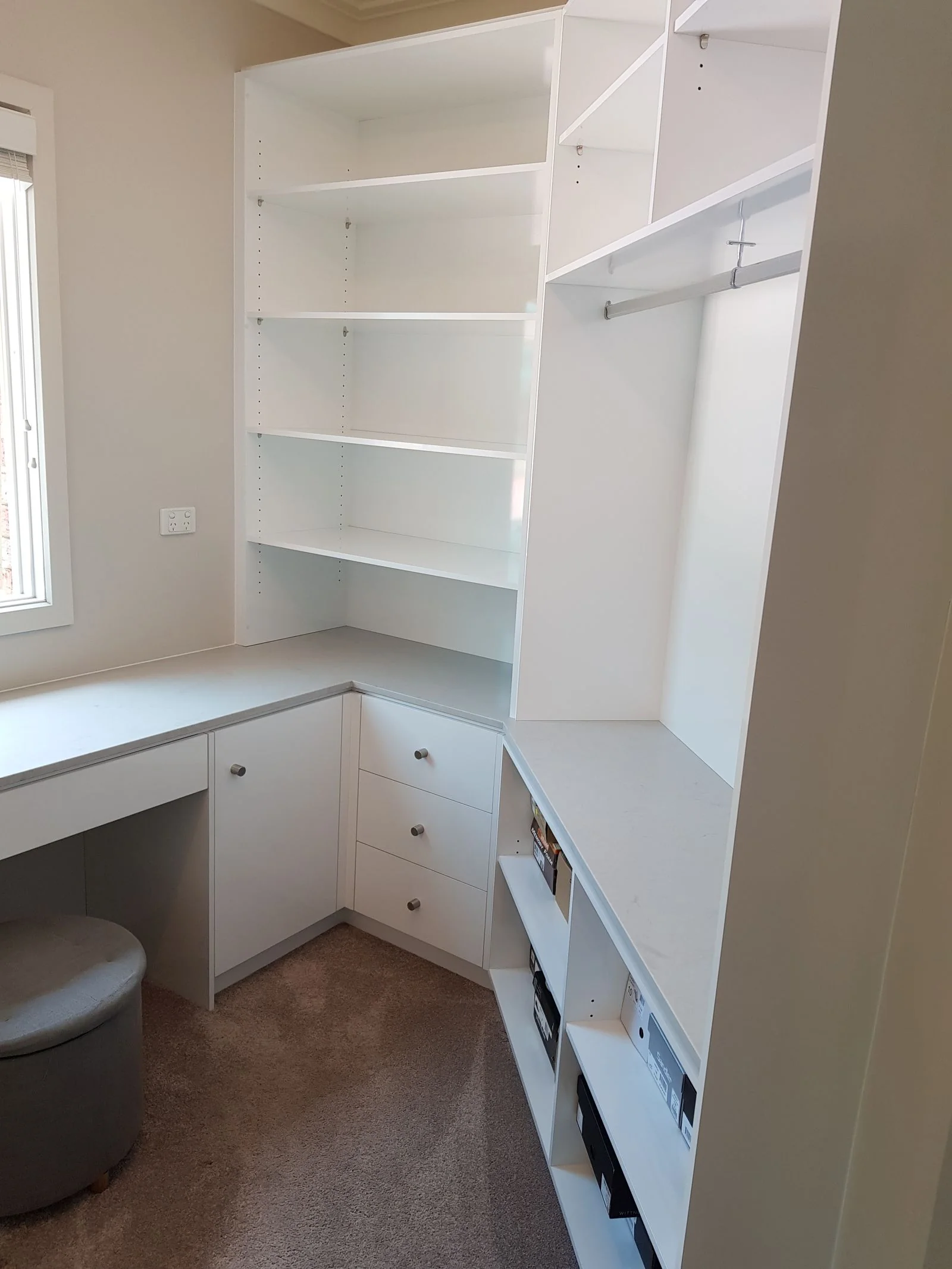 Built-in wardrobe with timber-look hinged doors and brass handles