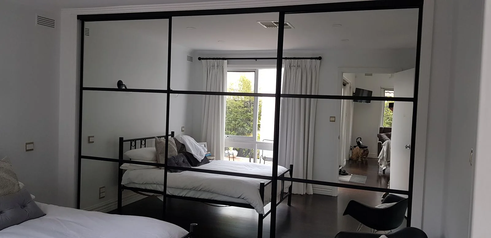 Built-in wardrobe with white hinged doors and internal drawers