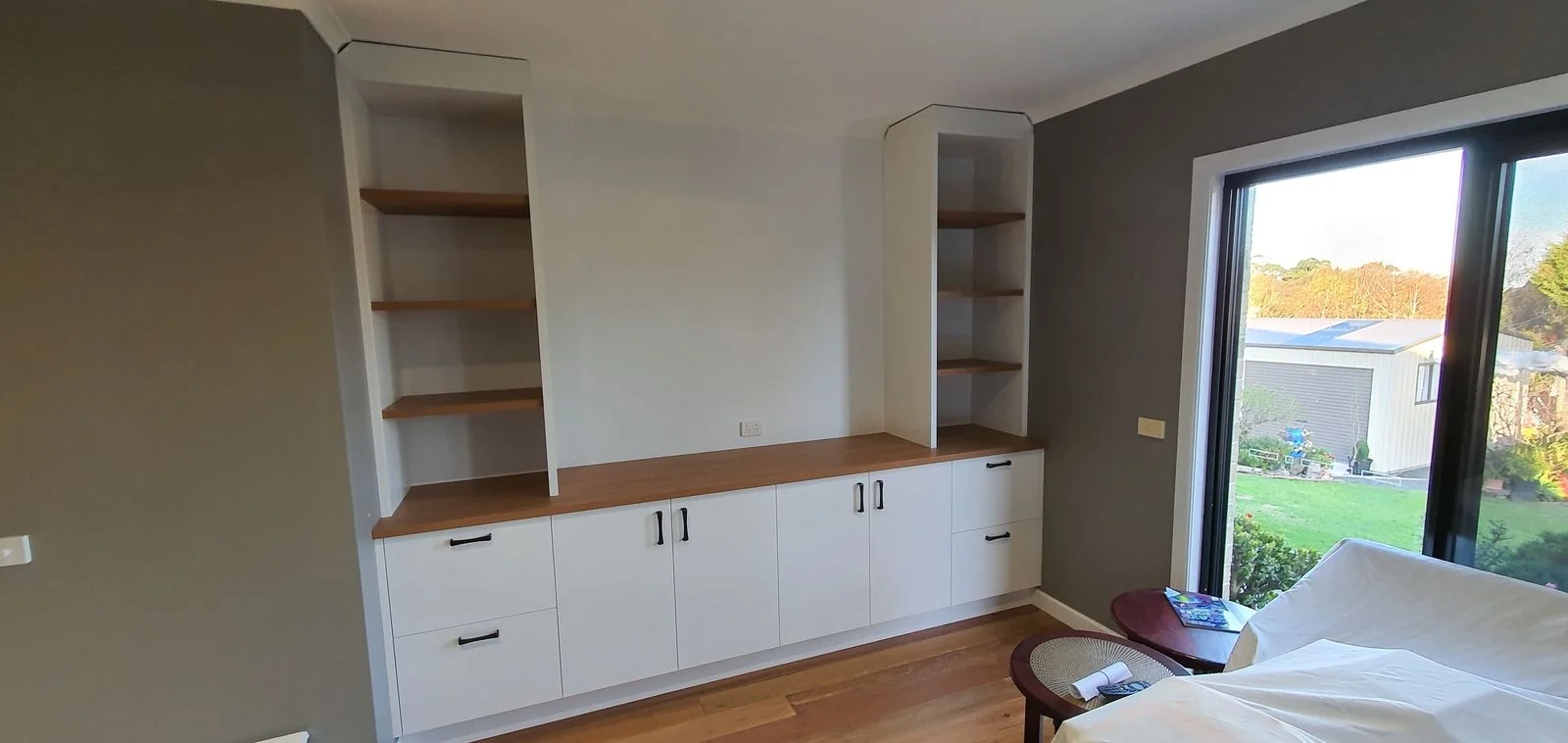Built-in wardrobe with white sliding doors in a modern bedroom