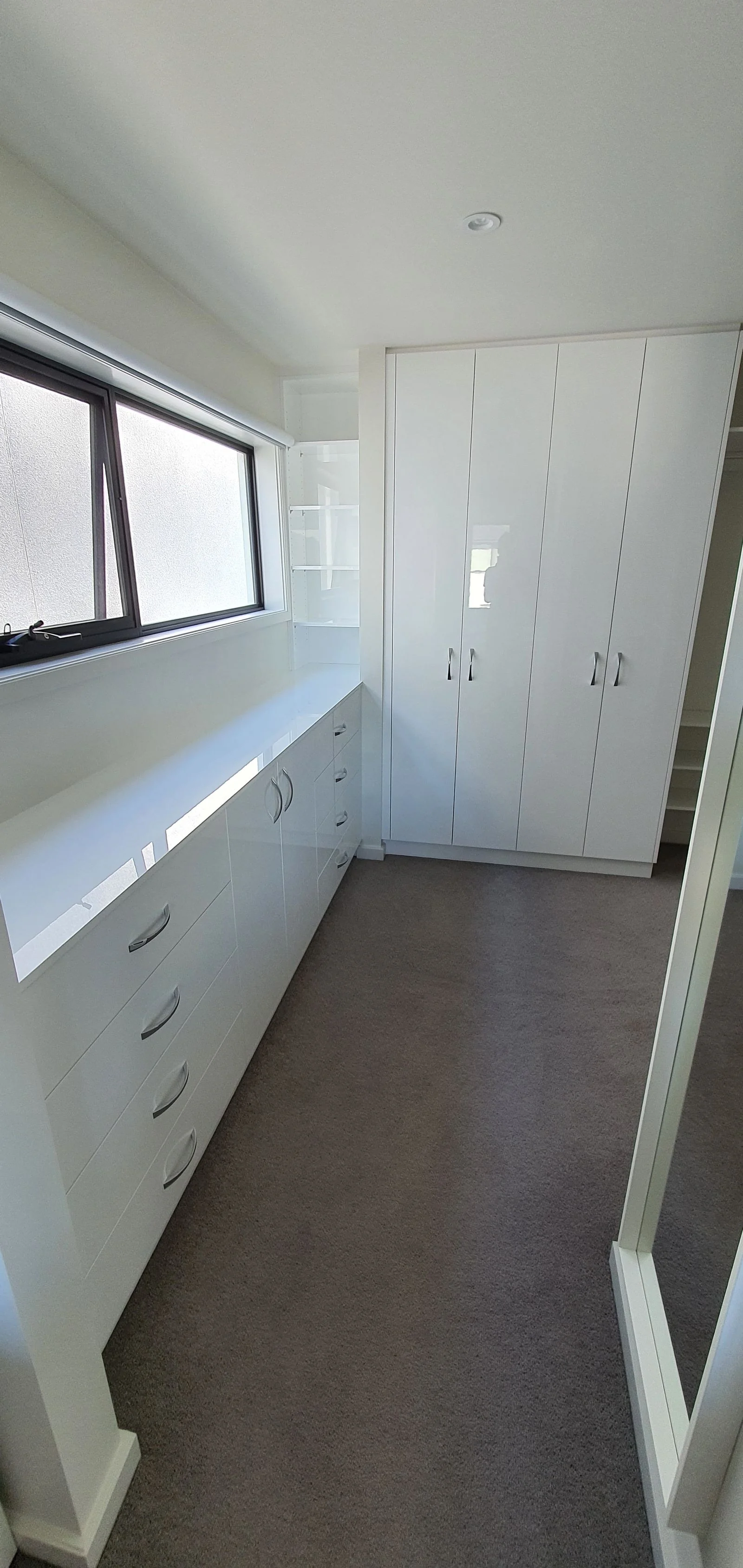 Built-in wardrobe with grey sliding doors in a bedroom