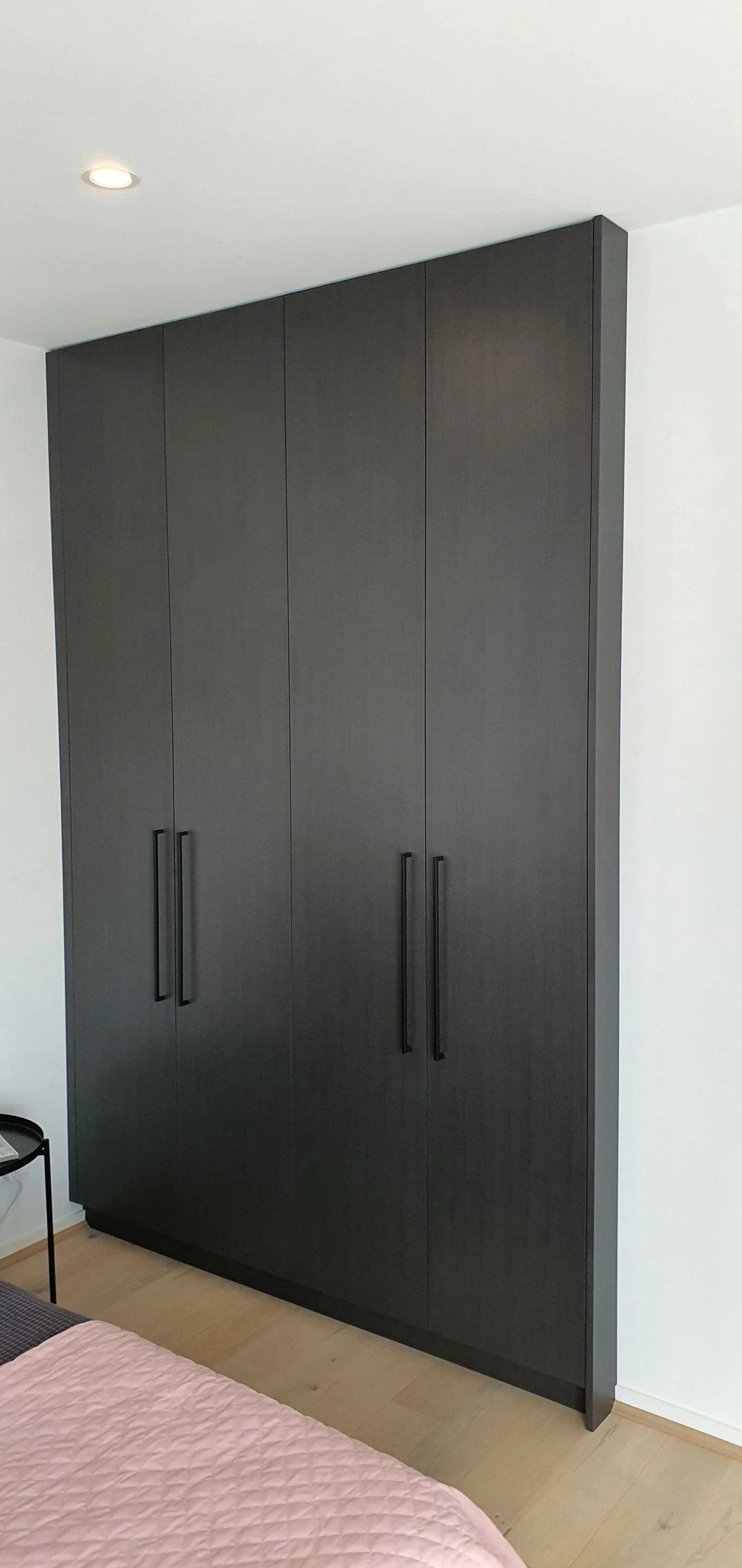 Built-in wardrobe with white sliding doors and mirror panel