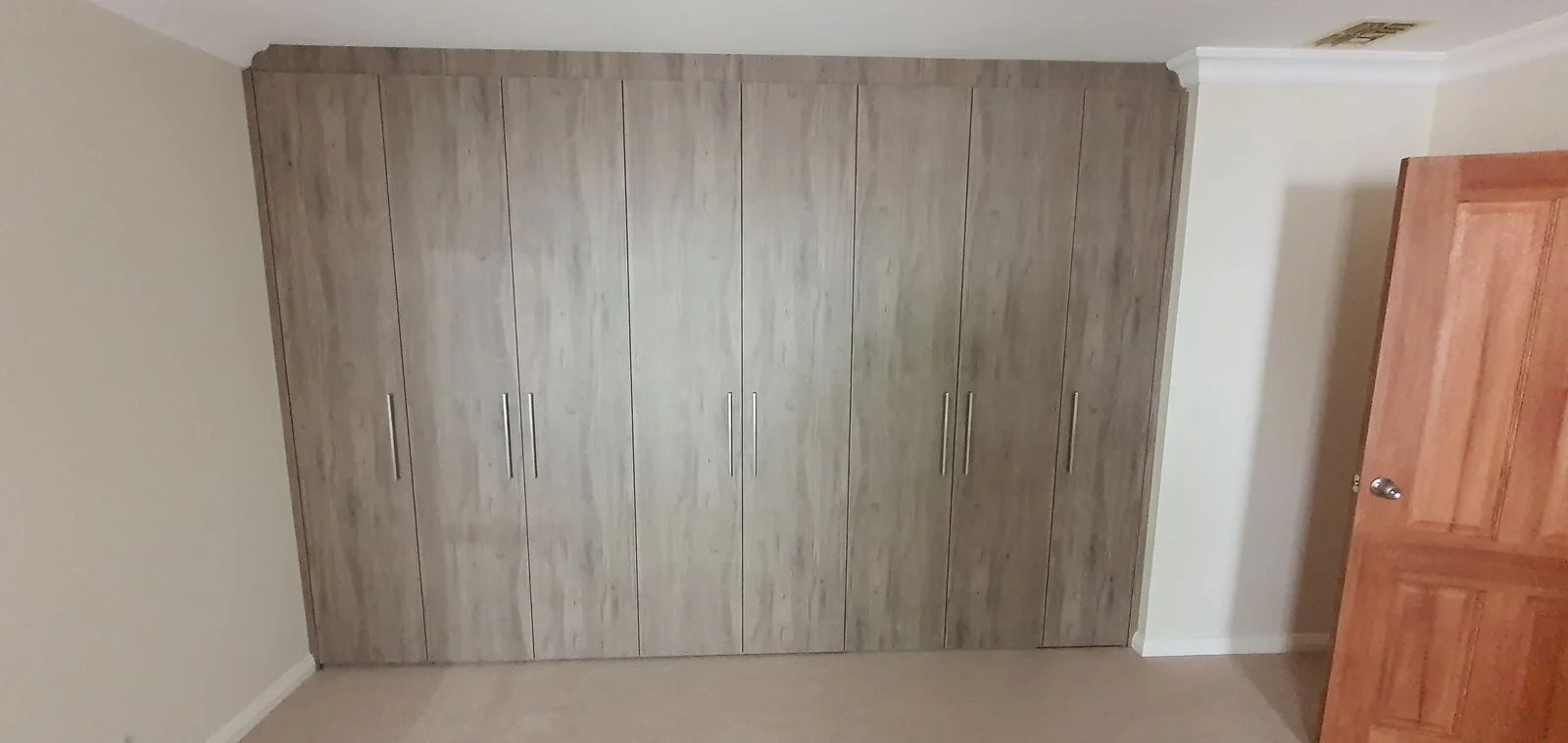Built-in wardrobe with timber-panel sliding doors