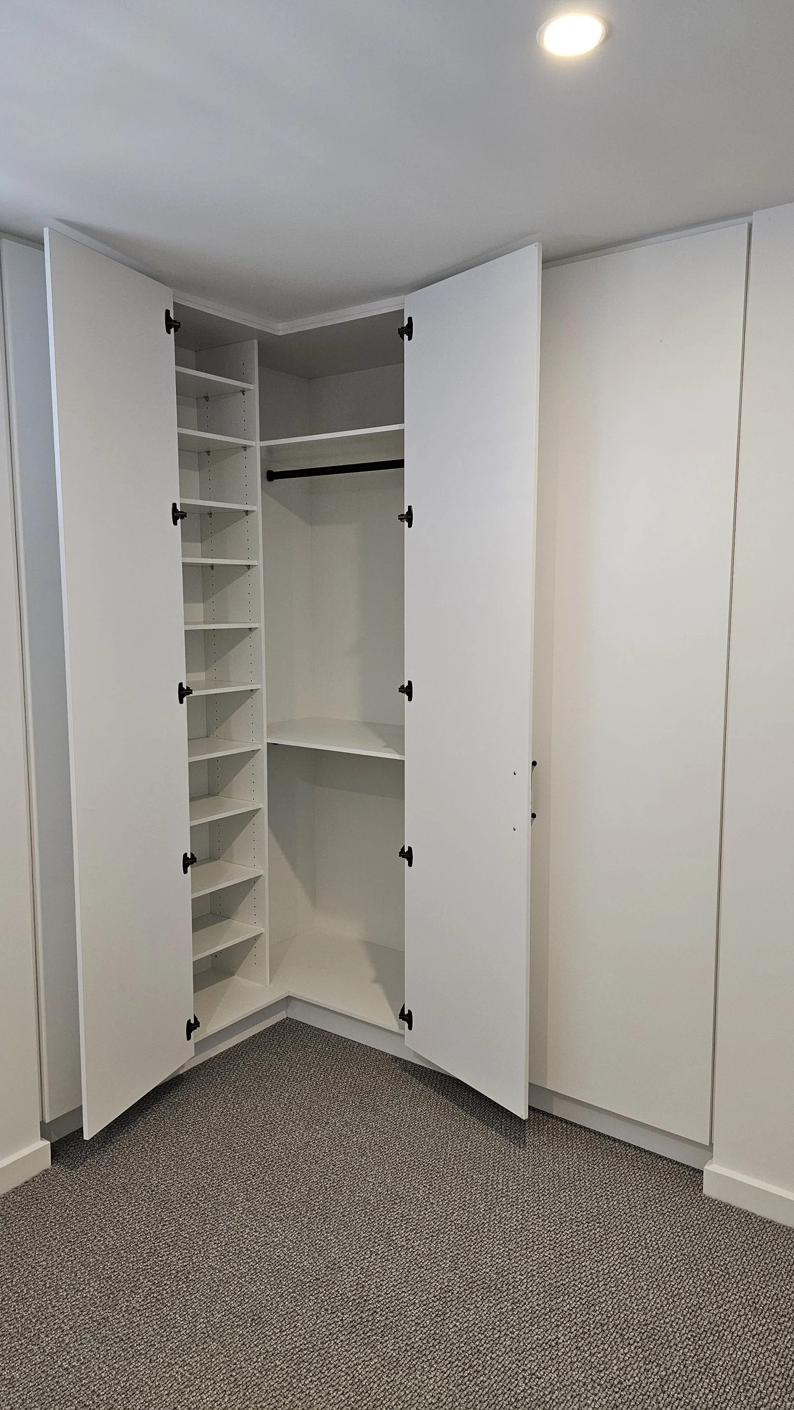 Modern wardrobe cabinetry fitted by Brodco in a coastal home