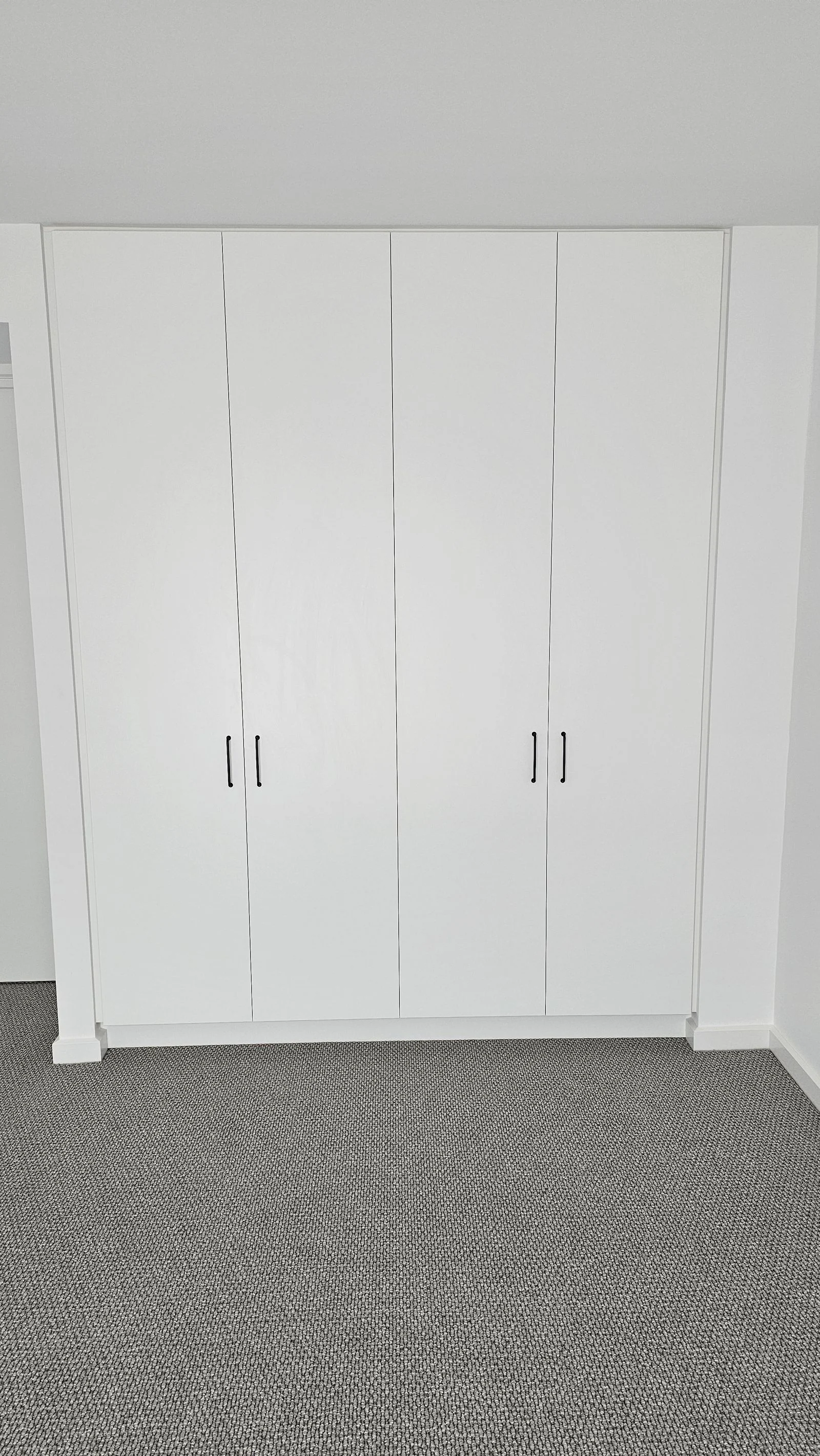 Built-in wardrobe with sliding doors installed by Brodco