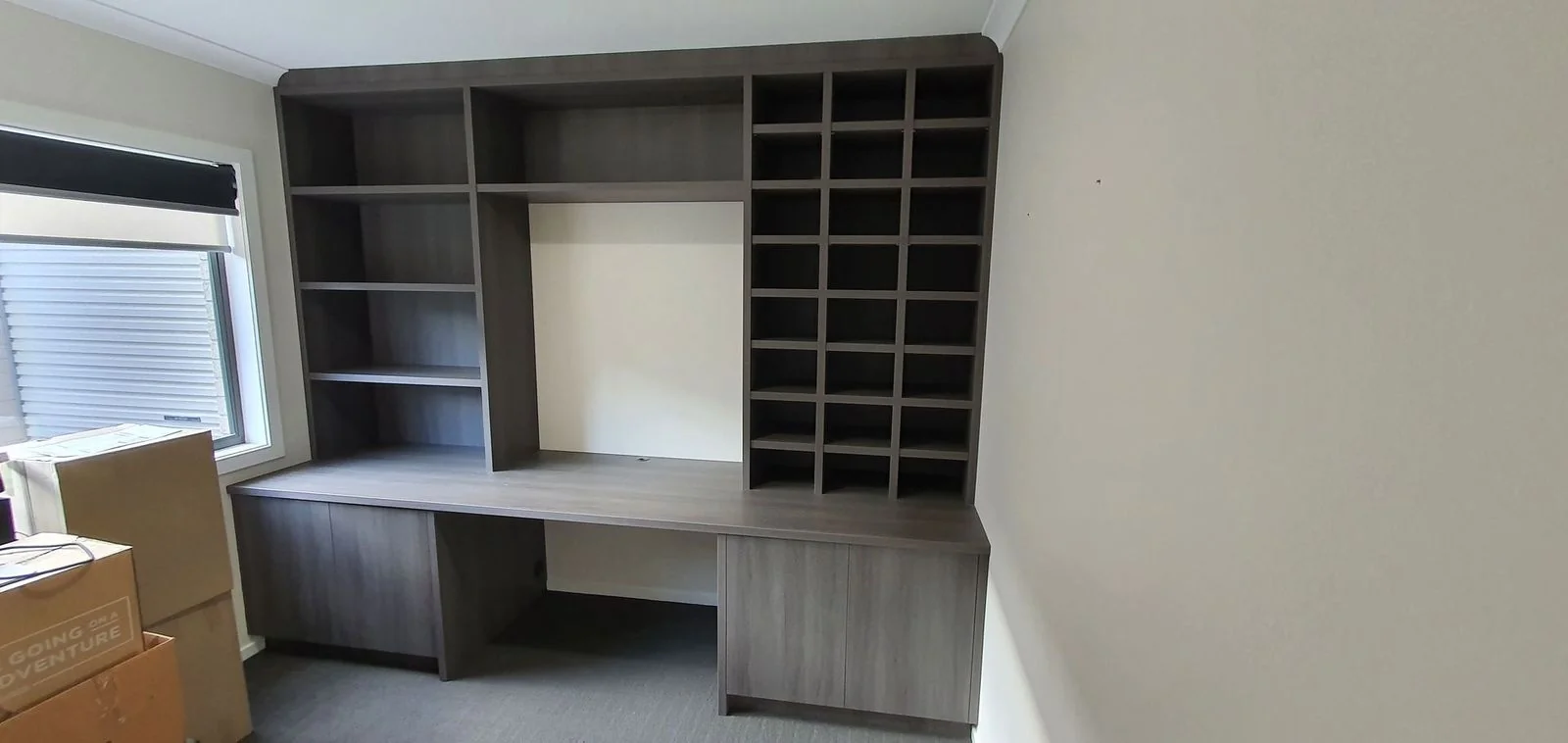 Built-in wardrobe with grey sliding doors and mirror panel