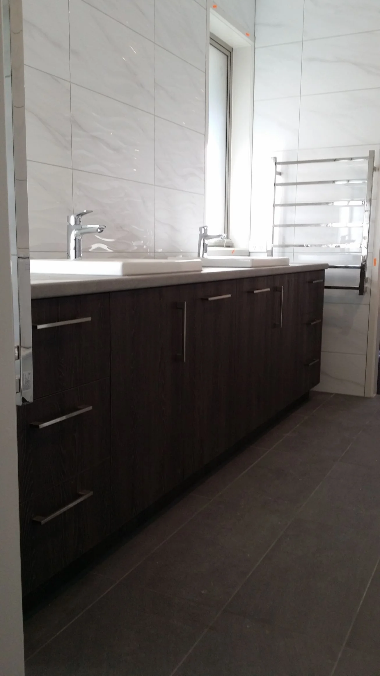 Built-in wardrobe with white hinged doors and brushed handles