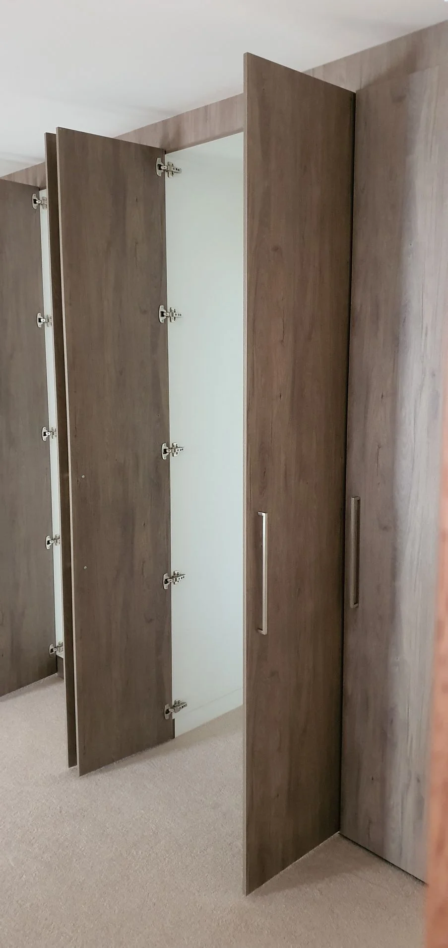 Built-in wardrobe with grey sliding doors in a bedroom