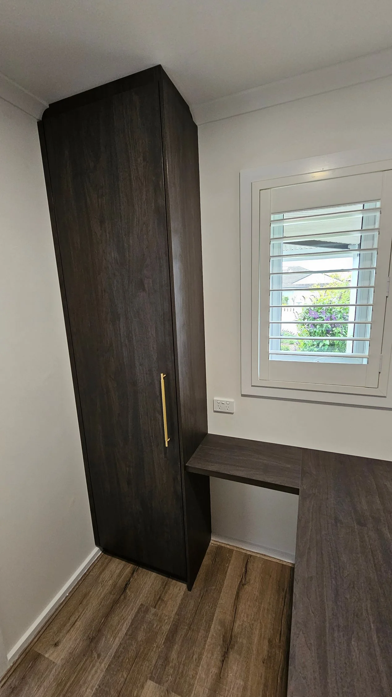 Built-in wardrobe with white sliding doors and floor-to-ceiling storage
