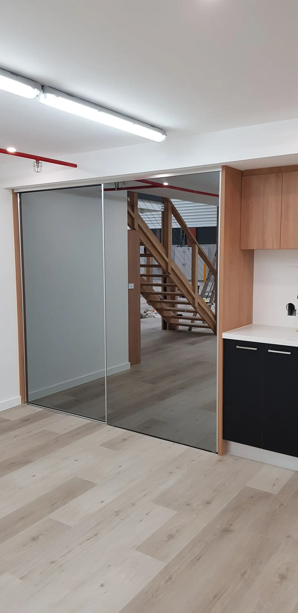 Slim-framed sliding wardrobe doors in a large bedroom