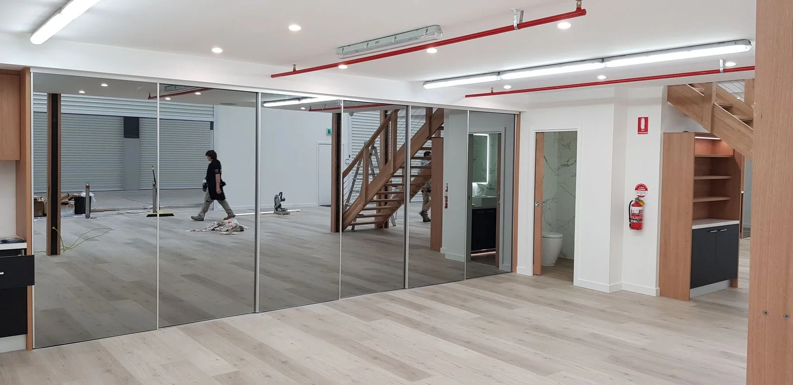 Built-in wardrobe with mirrored sliding doors and internal shelving visible