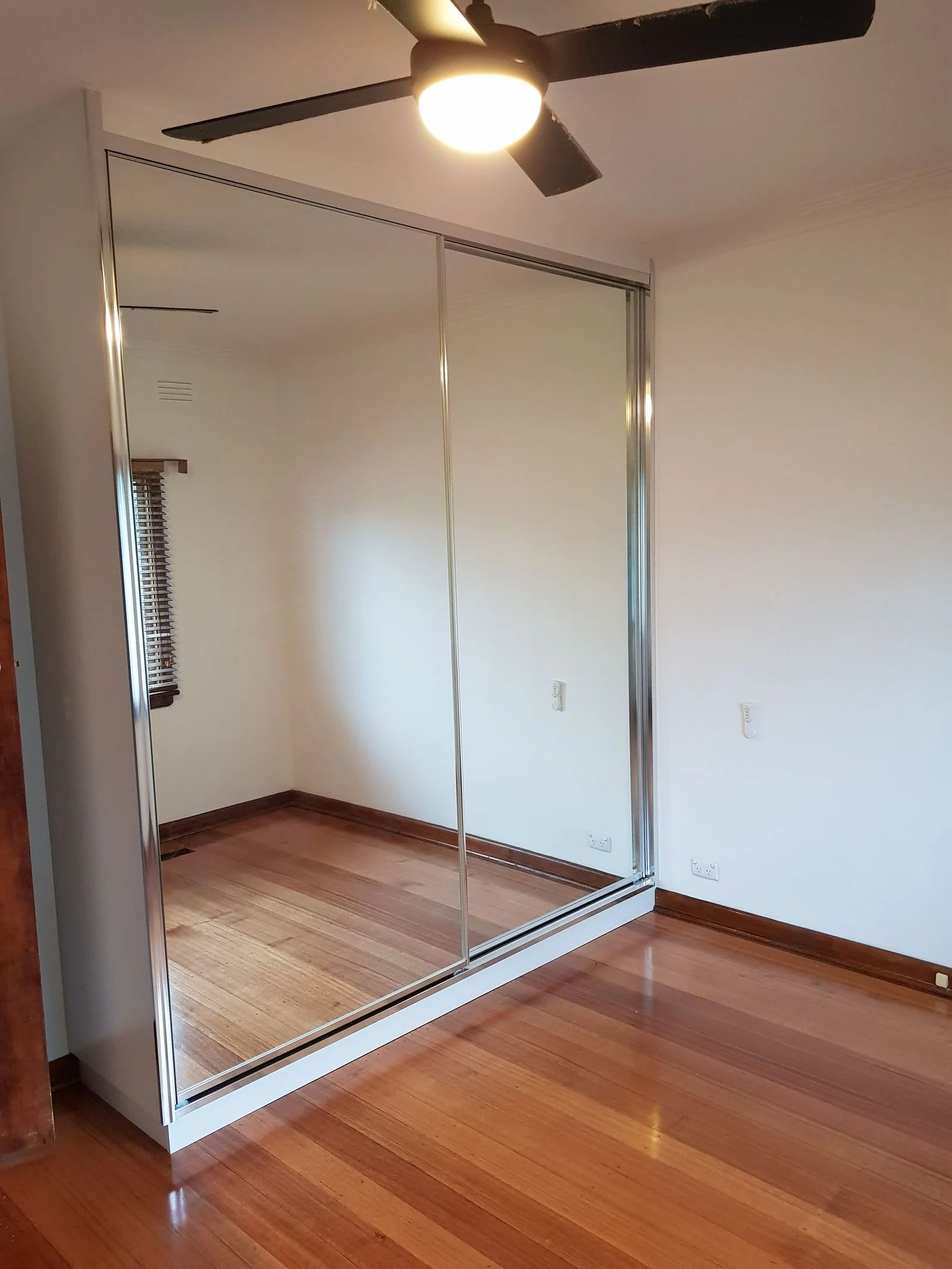 Sliding wardrobe doors with brushed-metal handles