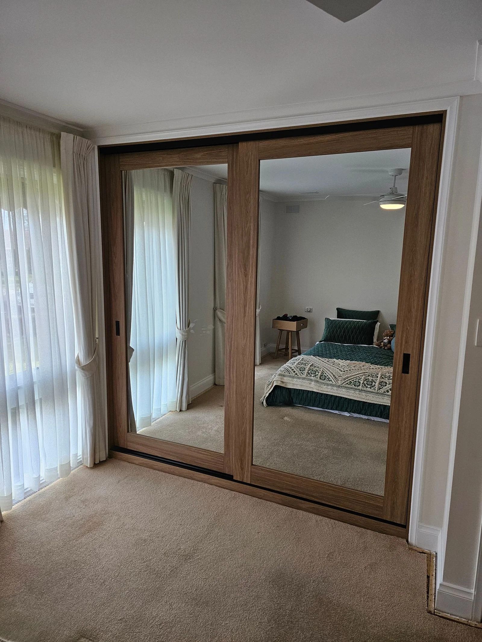 Sliding wardrobe doors in a compact bedroom