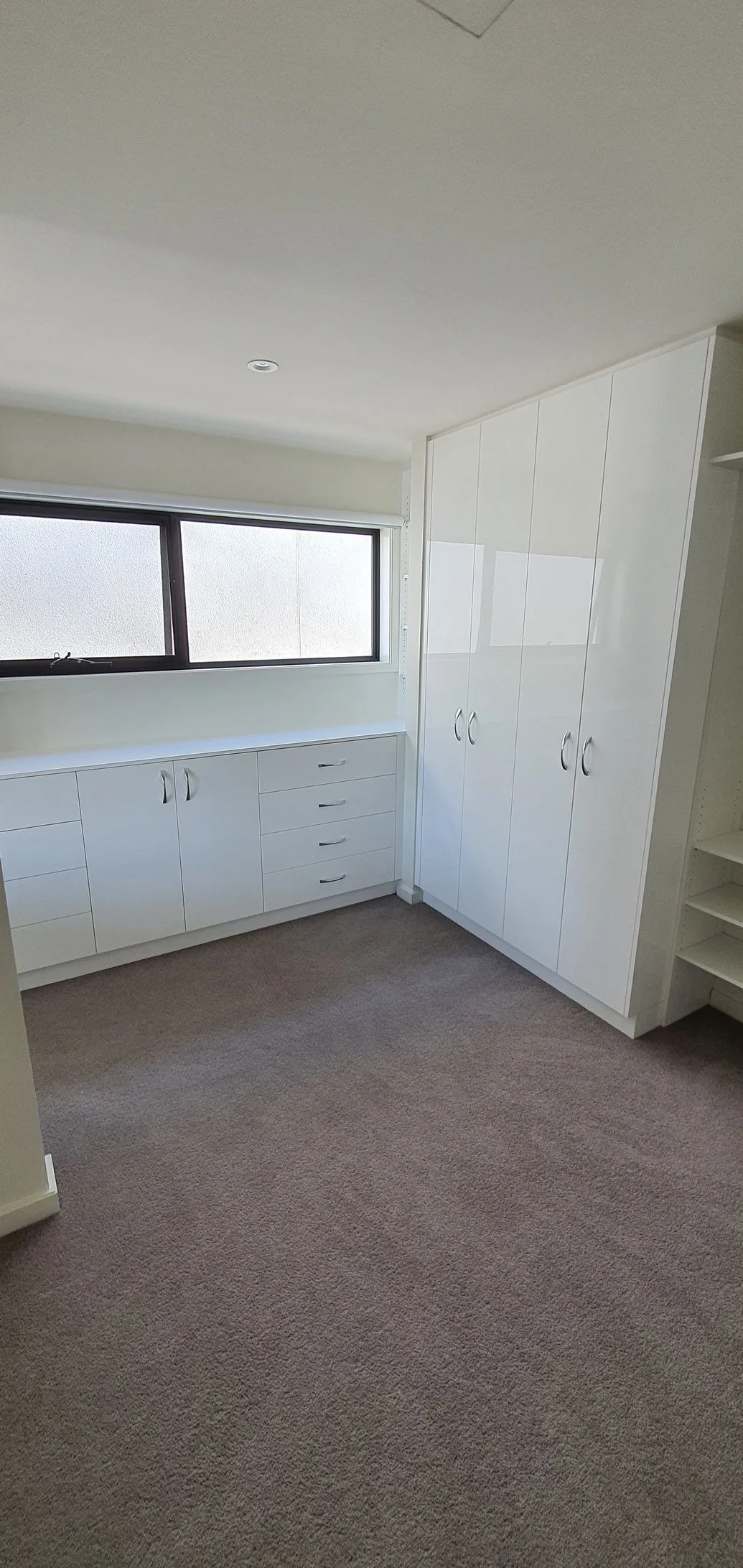 Open walk-in wardrobe with drawers and hanging space