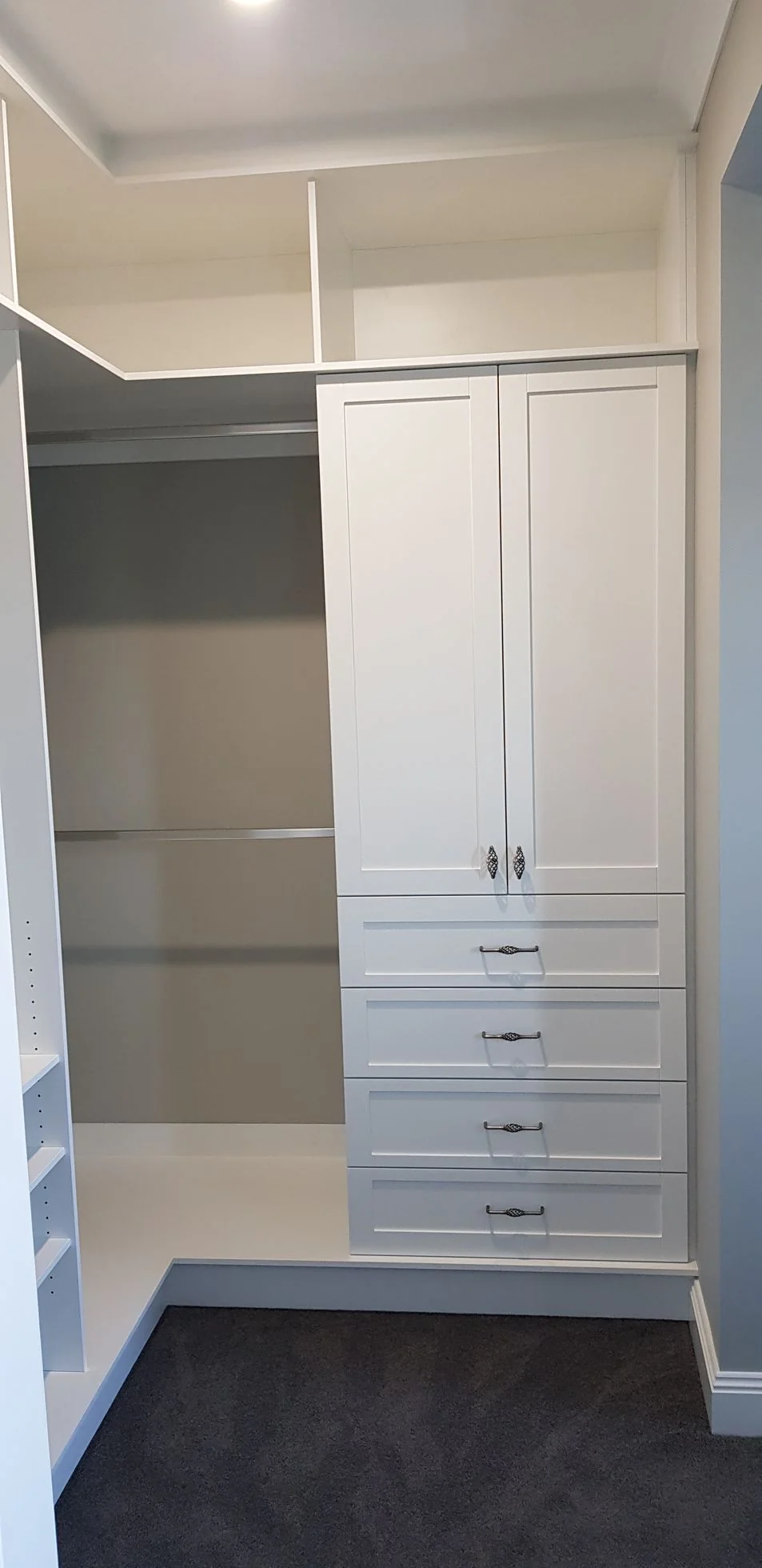 Built-in wardrobe with grey sliding doors in a bedroom