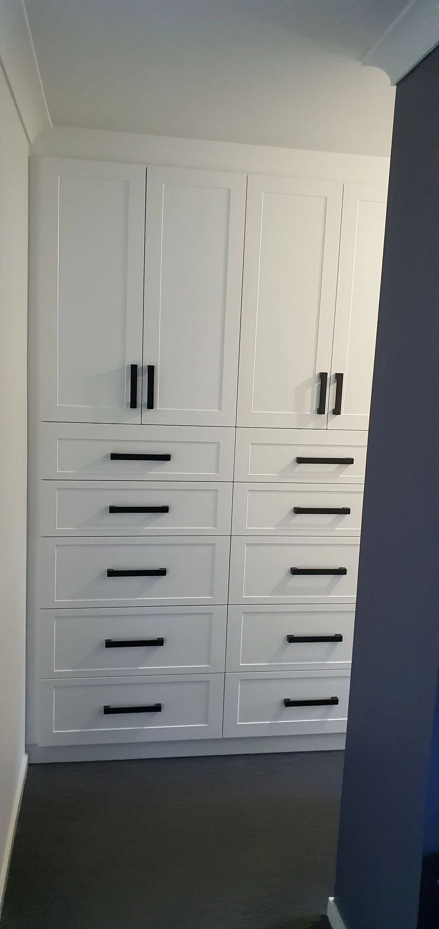 Walk-in wardrobe with central island and drawer storage