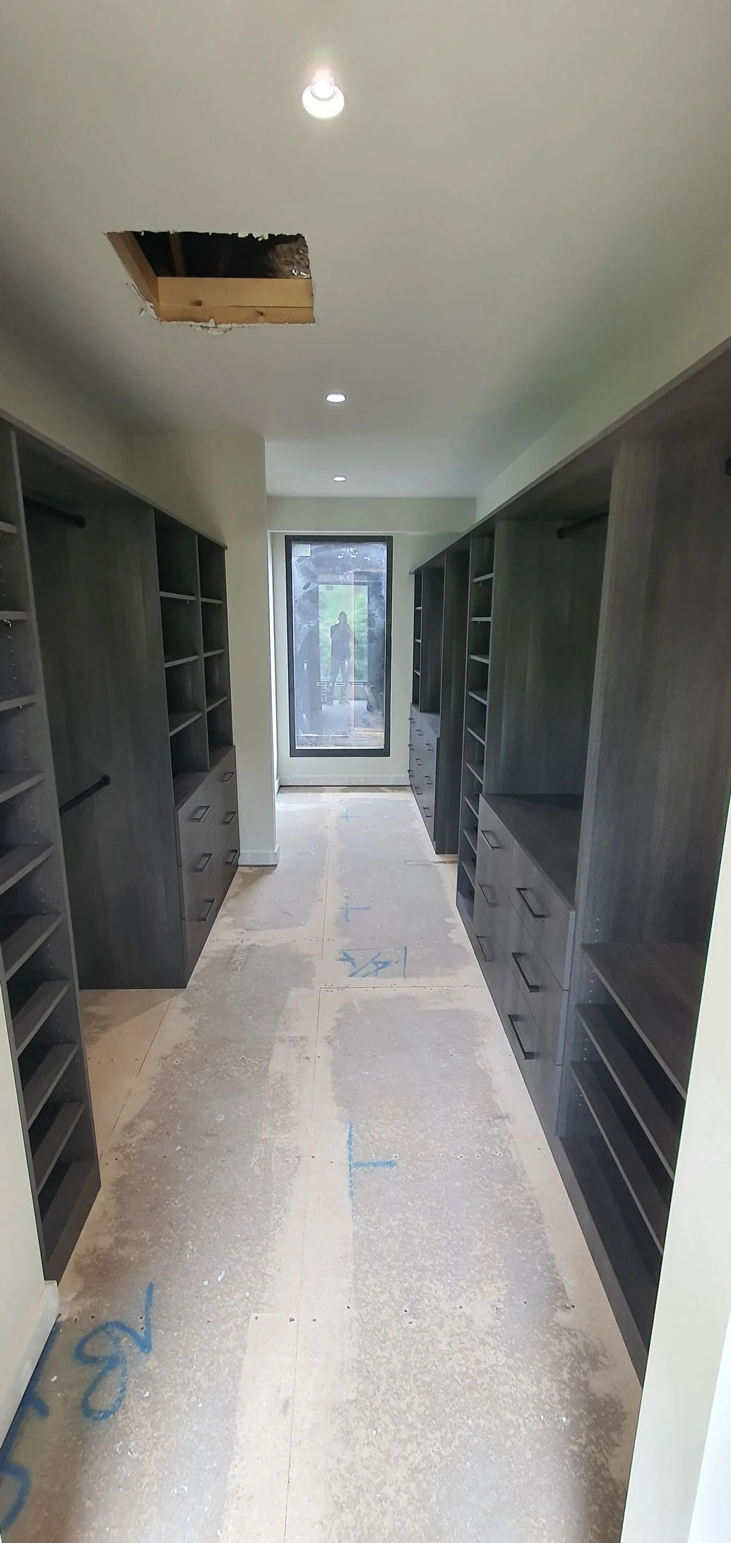 Built-in wardrobe with white sliding doors in a bright bedroom
