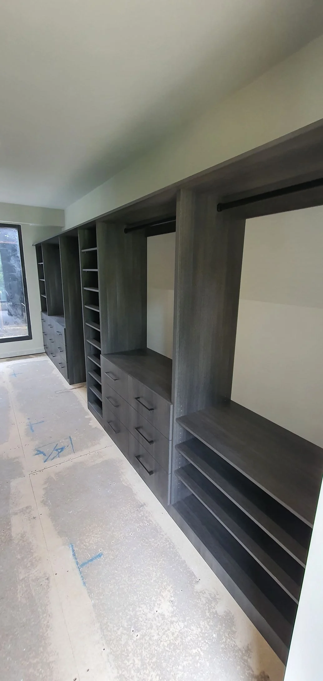 Built-in wardrobe with mirrored sliding doors and internal shelving