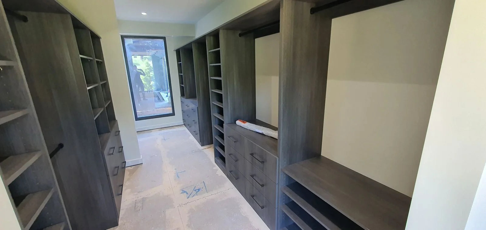 Built-in wardrobe with white hinged doors and floor-to-ceiling storage