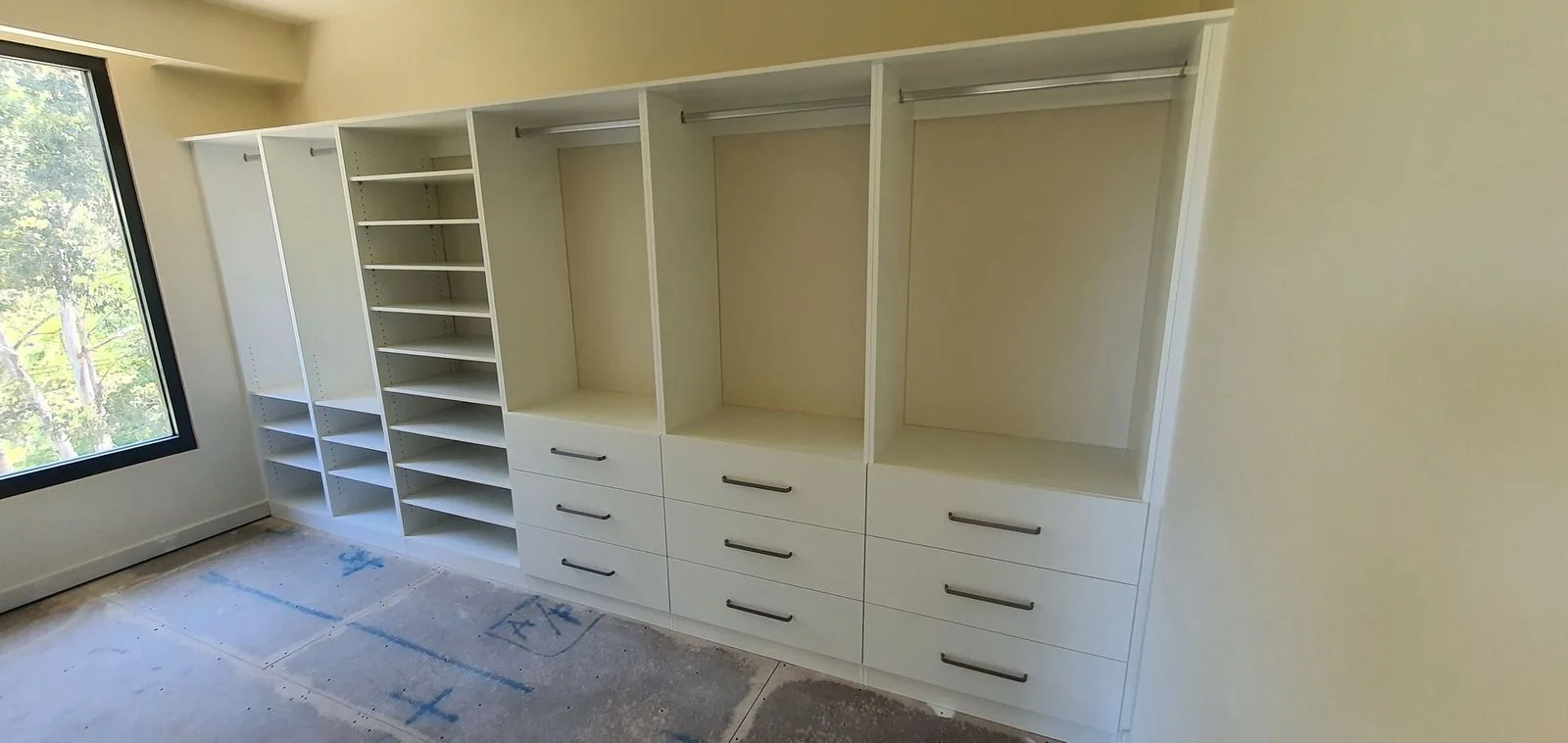 Compact walk-in wardrobe with shelving on both sides